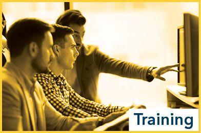 Training text overlaid upon three men looking at a computer monitor